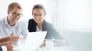 employees-reviewing-documents-white-desk