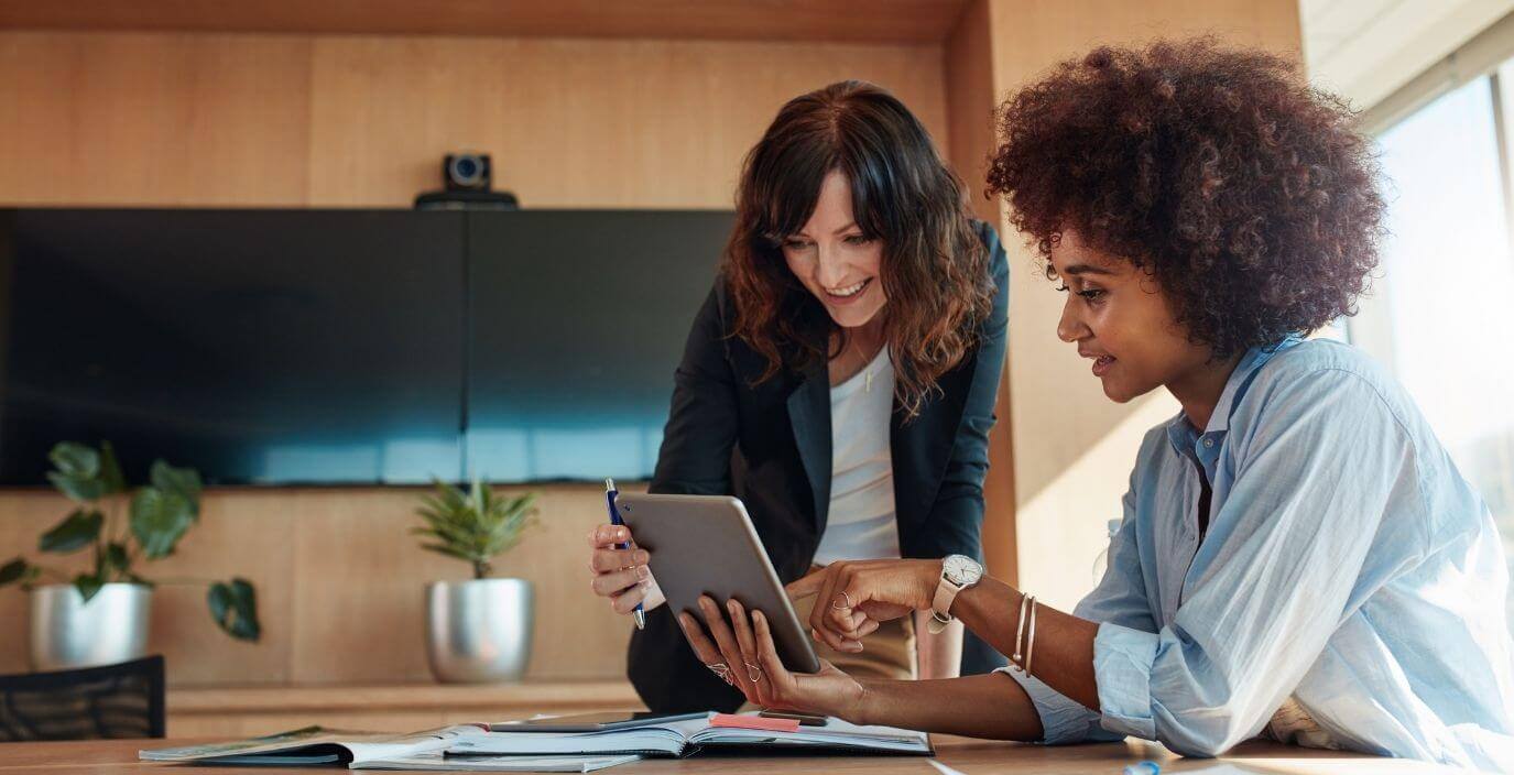 two-female-employees-with-ipad-in-office-blog